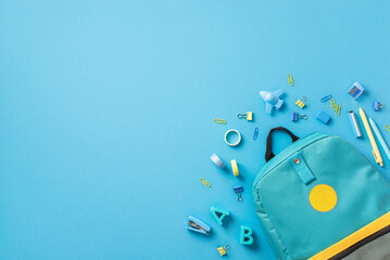 Back to school concept. Top view photo of blue rucksack plastic alphabet letters binder clips plane...