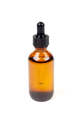 Essential oil in amber bottle isolate on white background.