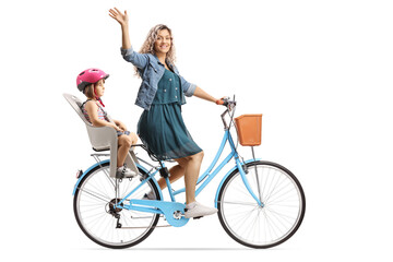 Mother waving and riding a bicycle with a girl in a child seat