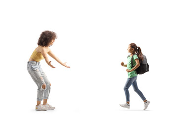Full length profile shot of a schoolgirl with a backpack running towards a young woman