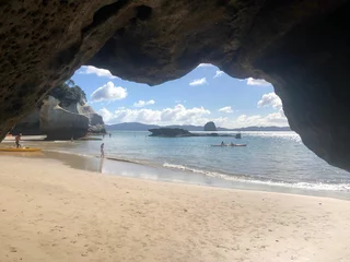 Fotobehang Beautiful view of the Cathedral Cove, Marine Reserve by the sunny sea water in New Zealand © Lucia Wei/Wirestock Creators
