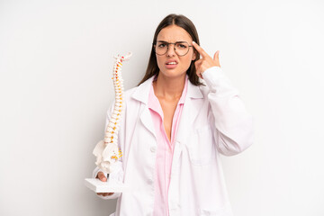 pretty woman feeling confused and puzzled, showing you are insane. spine specialist concept