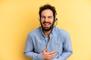 young man laughing out loud at some hilarious joke. telemarketer concept