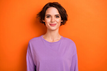 Photo of charming adorable girl dressed purple pullover smiling isolated orange color background