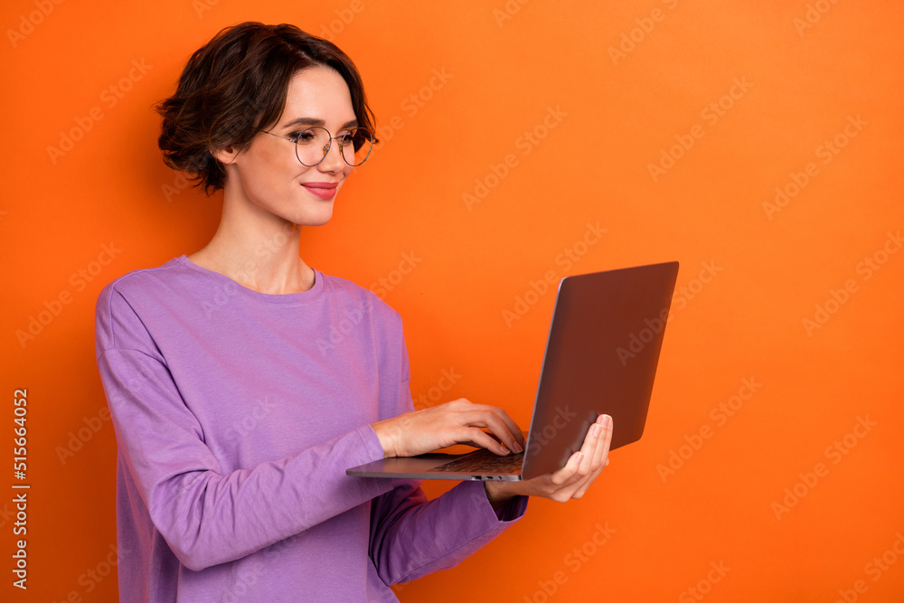 Aufkleber portrait of smart positive lady hold use wireless netbook write email isolated on orange color backg