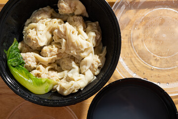 takeout bowls of wontons and the soup