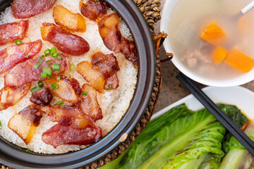 top view clay pot rice of Chinese style sausage and air-dried bacon with soup and cabbage horizontal composition