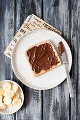 Breakfast toast with nut nougat cream, bananas and berries