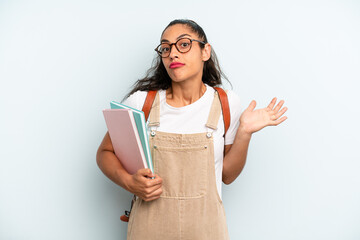 hispanic woman feeling puzzled and confused and doubting. university student concept