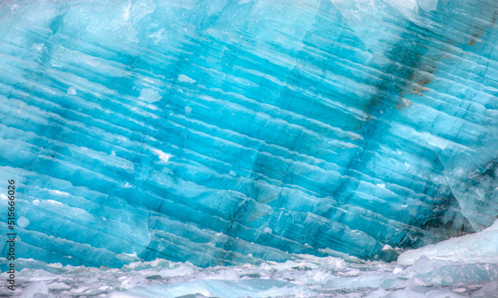 Wall mural a close-up of the layered surface of a blue glacier - knud rasmussen glacier near kulusuk - greenlan