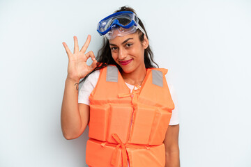 hispanic woman feeling happy, showing approval with okay gesture. life jacket and summer concept