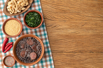 Typical brazilian feijoada with caipirinha, farofa, cracklings and copy space
