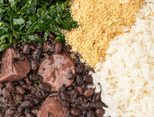 Closeup of typical brazilian feijoada with rice, farofa and kale