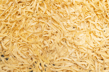 Homemade italian pasta Fettuccine or Pappardelle on dark table, close-up. Selective focus. Design element