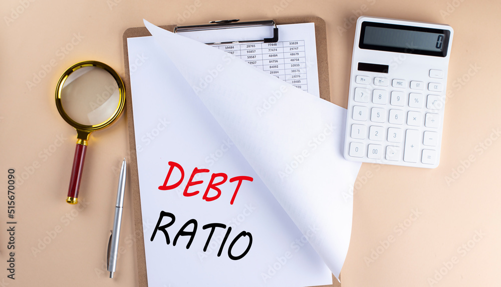 Poster clipboard with chart and text debt ratio with magnifier ,calculator on beige background