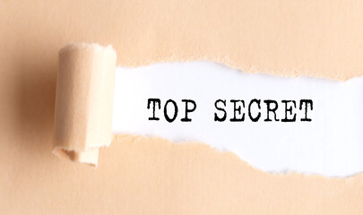 The text TOP SECRET appears on torn paper on white background.