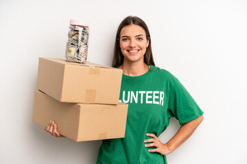 pretty woman smiling happily with a hand on hip and confident. volunteer and donation concept