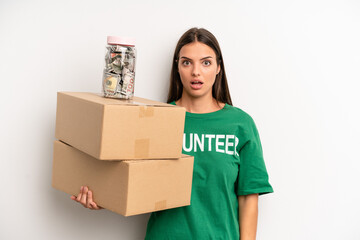 pretty woman looking very shocked or surprised. volunteer and donation concept