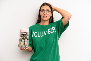 pretty woman feeling stressed, anxious or scared, with hands on head. volunteer and donation concept