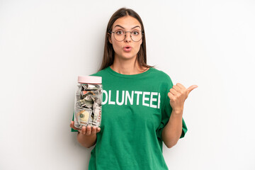 pretty woman looking astonished in disbelief. volunteer and donation concept