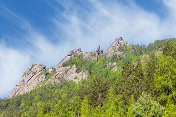 Fototapeta na wymiar Summer mountain landscape of the Takmak rock pillar in the national natural park of Krasnoyarsk Pillars. Stolby Nature Sanctuary at Krasnoyarsk, Russia