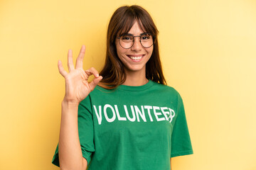 pretty woman feeling happy, showing approval with okay gesture. volunteer and donation concept