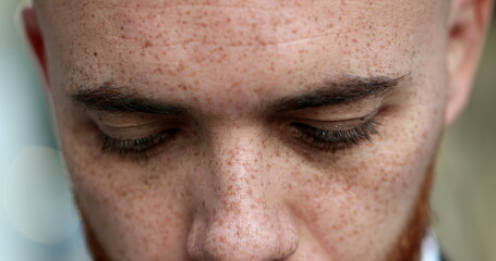 Fototapeta premium White man opening eyes looking at camera and smiling, close-up portrait face