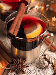 Tasty mulled wine with lemon slices and cinnamon on a rustic wooden table, seasonal food concept, Christmas time background