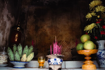 Fruits and incense offering in a Buddhist altar in Vietnam