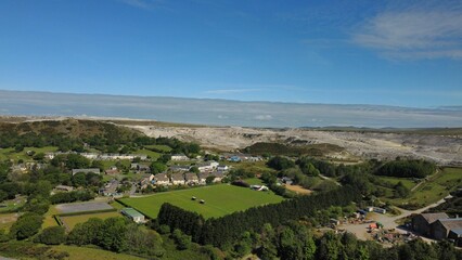 Bird's eye view of a green landscape covered with houses in Lee Moor, Devon, England
