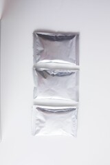 Top view of blank sachets for supplements isolated on white background