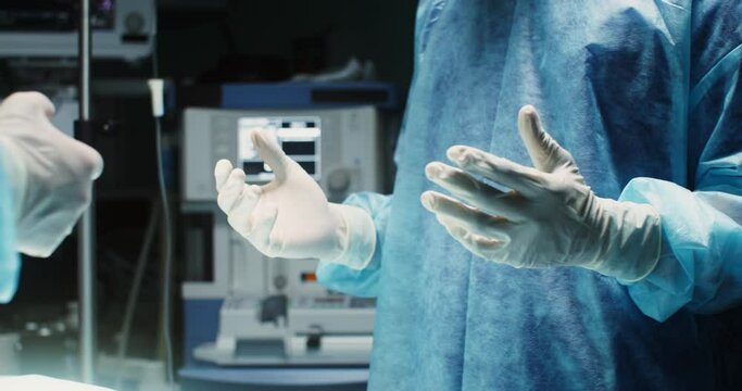 A team of surgeons perform an operation in a bright operating room