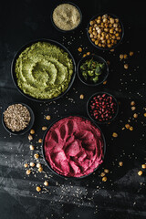 Obraz na płótnie Canvas Beetroot hummus and spinach hummus. Vegan recipes, plant-based dishes. Homemade healthy organic food. Vegetarian cuisine. Top view 