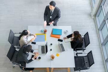 A group of young Asian businessmen Talking and planning work happily and have fun. at the company's office