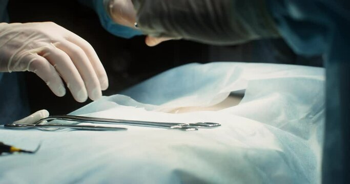 A team of surgeons perform an operation in a bright operating room