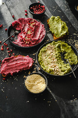 Beetroot hummus and spinach hummus. Vegan recipes, plant-based dishes. Homemade healthy organic food. Vegetarian cuisine. Top view 