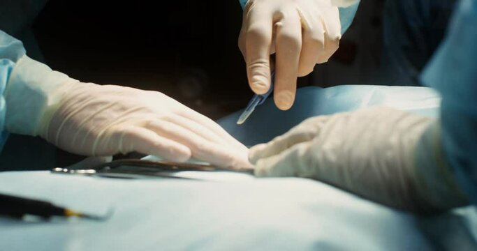 A team of surgeons perform an operation in a bright operating room