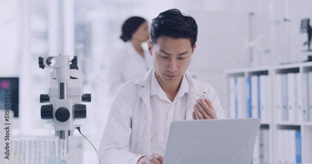 Aufkleber Scientist using a laptop while analyzing test tubes of samples in a lab. Male pathologist doing forensic research while assessing data online. Clinical researcher recording results from experiments