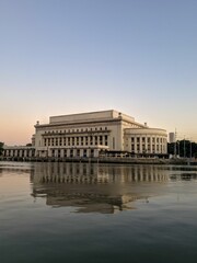 Manila Central Post Office fronting the Pasig River in the Philippines during sunset