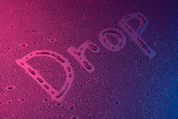 Word - Drop,Handwritten text on wet glass,Water drops on the window glass