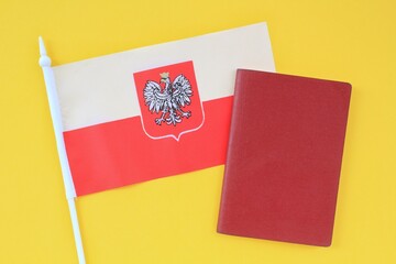 National passport and flag of Poland on yellow background. Immigration, refugee, change of...