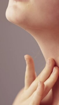 Vertical video. Body care. Sensual woman. Beauty spa. Unrecognizable profile elegant lady tenderly touching face neck zone with hand.