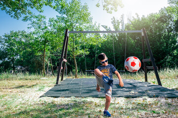 child laughing and kicking ball