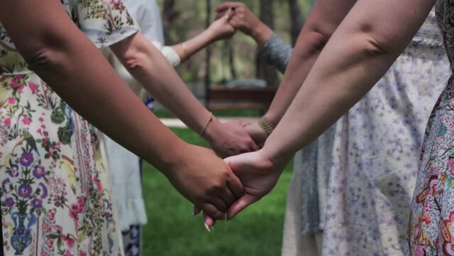 Women in traditional dresses holding hands at a folk festival