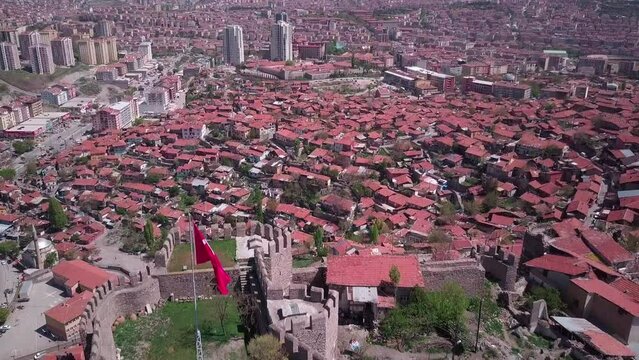 Top of the hill with Ancient Ankara fortress, Turkish flag, main city view. Aerial shot.