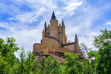 Fototapeta na wymiar Panoramic view of the medieval castle, Alcazar de Segovia, rising majestically to the sky.