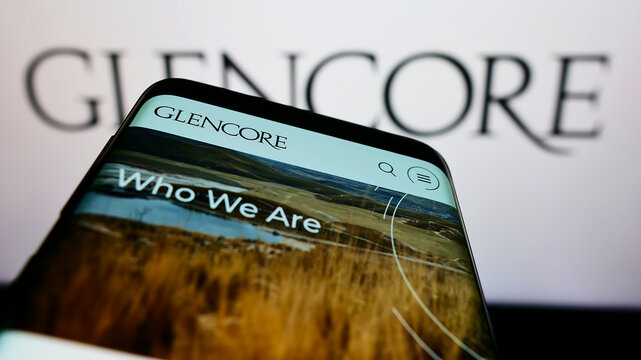 Stuttgart, Germany - 01-28-2022: Mobile phone with website of commodity trading company Glencore plc on screen in front of business logo. Focus on top-left of phone display.