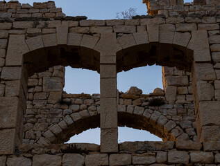 stone arches of an old factory in ruins that form a threatening face