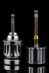 two professional dental orthopedic screwdrivers on a black background
