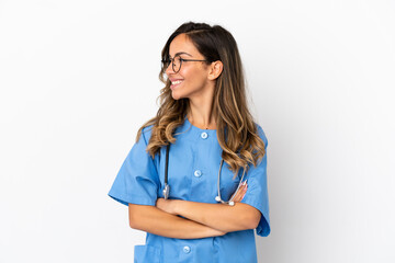 Young surgeon doctor woman over isolated white wall looking side